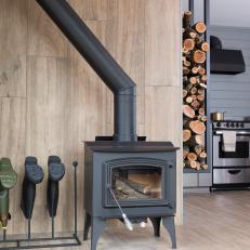 Neutral Foyer with Black Wood Burning Stove and Boot Rack
