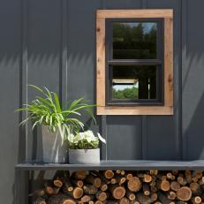 Black Cabin Home Exterior with Neutral Window Frame 