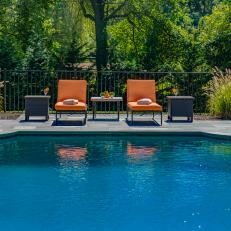 Swimming Pool With Orange Lounge Chairs