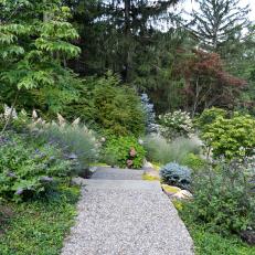 Foliage Overlaps Garden Path to Create a Natural Feel