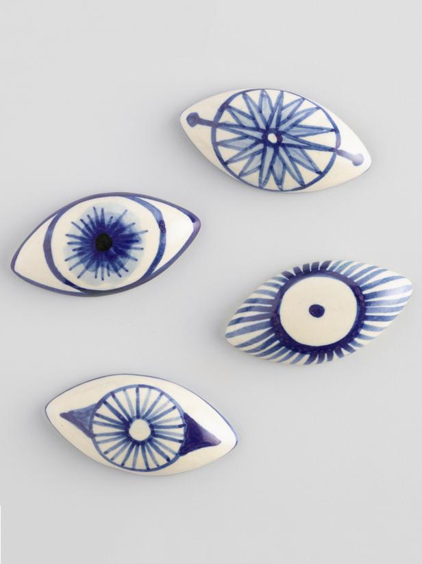 Four Ceramic Ovals With Painted Eyes