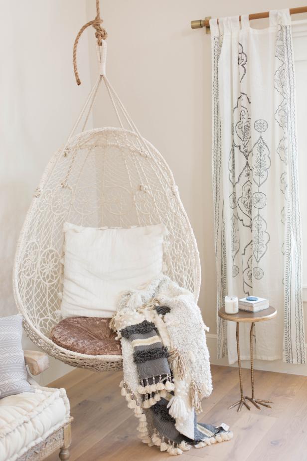 Cozy Hanging Chair With Pom Pom Throw in Teen's Room | HGTV