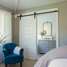 Master Bedroom With Blue Chair and Barn Door
