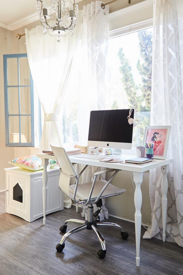 The office is where Camille works from home. The space is flooded with light with windows that look out onto the home’s front lawn. The window trim has been painted in a crisp blue, a perfect fit with the home’s pink and blue color palette. A desk with turned legs brings some traditional style home. Camille is great at mixing styles, and a modern Eames office chair in white fits seamlessly into the space. A retreat for the couple’s puppy also fits into the home office decor. 