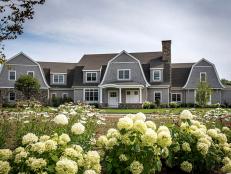 Gray Farmhouse Exterior With White Hydrangeas