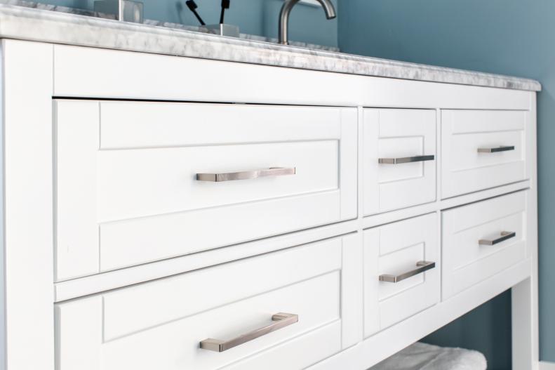 The drawers on the double vanity include long stainless pulls with clean lines that fit with the easy modern style of this versatile space. 