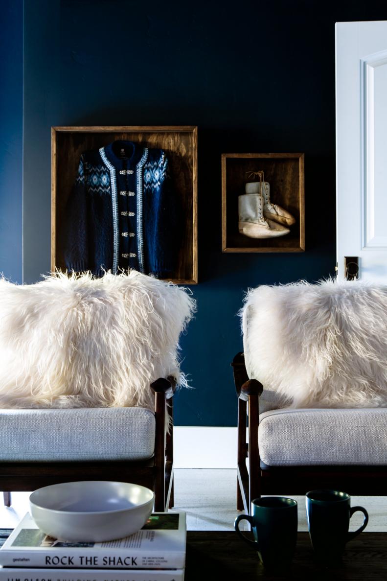 Soft textures like these sheep-skin pillows bring the beauty of nature into the style of this relaxing retreat. Using pops of white against the dark blue and wood tones echoes the color palette of Montana’s snowy winters.