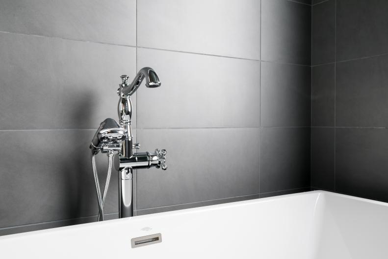 The classic lines on this traditional faucet and handheld showerhead add vintage charm to this state-of-the-art, walk-in shower and bath.