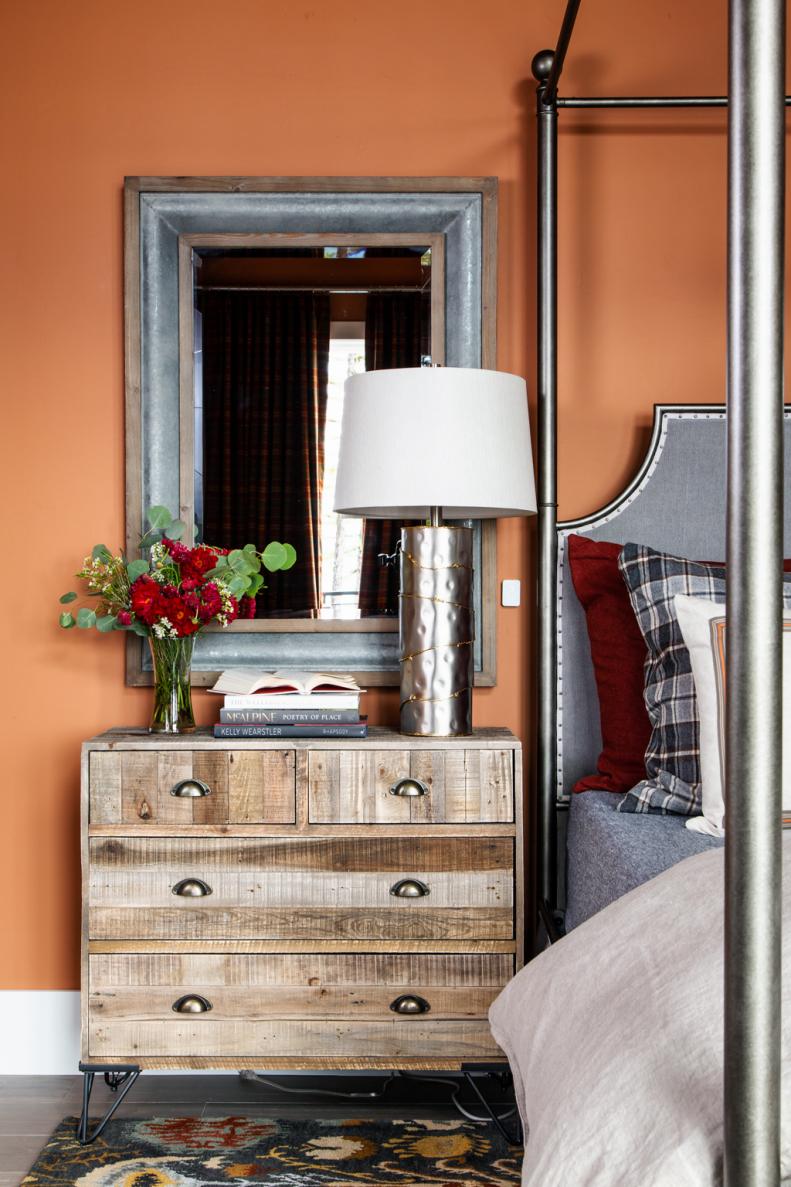 The bedside table combines vintage style metal pulls with rustic barn wood to add warmth and natural style to the master suite.