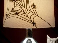 HGTV shows you how to make your own spiderweb lampshade halloween decoration.