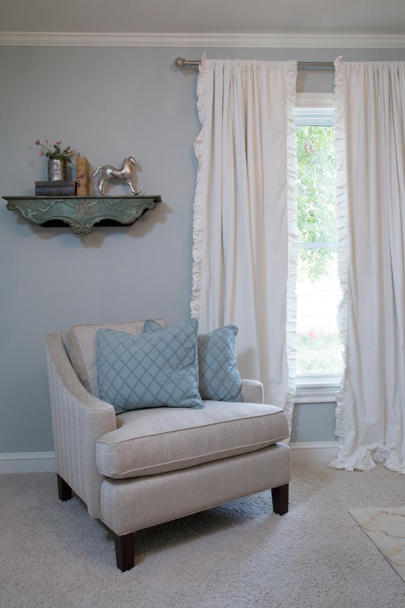 An inviting side chair is a comfortable place to sit with the new baby, and thick white curtains will help keep the nursery dark for those daytime naps as seen on HGTV's Fixer Upper. (details)