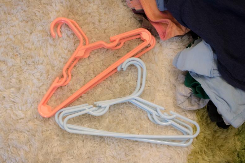 Hanger colors help to keep kid's clothes organized in shared closets.