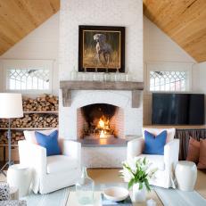 Cozy Den Features Oil Painting Over Fireplace Mantel
