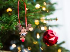 Not sure what to do with that old puzzle that's missing a few pieces? Repurpose it into cute reindeer ornaments for your Christmas tree.