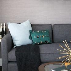 Gray Sofa and Gold Sculpture