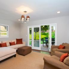 Neutral Media Room With Orange Pillows