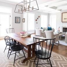 Transitional Dining Room Complete With Caged Chandelier, Patterned Rug