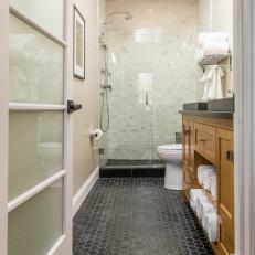 Transitional Master Bathroom With Black Pennytile Floors