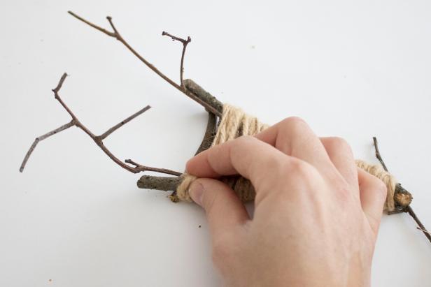Help your kids make memorable handmade ornaments from natural sticks and colorful fibers.