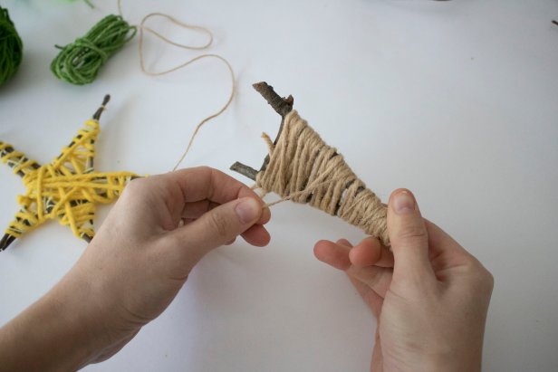 Help your kids make memorable handmade ornaments from natural sticks and colorful fibers.