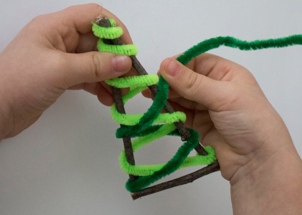 Help your kids make memorable handmade ornaments from natural sticks and colorful fibers.