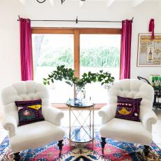 Multicolored Sitting Area With Tufted Armchairs