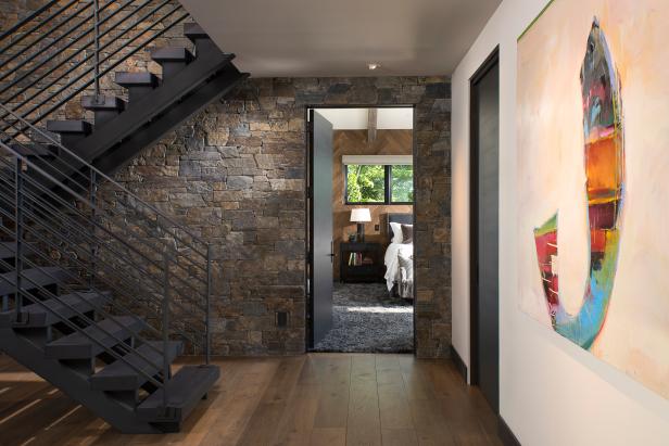 Modern Entryway With Dark Wood Stairs, Stone Accent Wall | HGTV