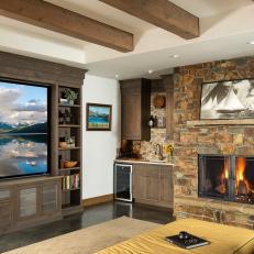 Modern Den Stays Cozy With Wood Beams, Stone Fireplace