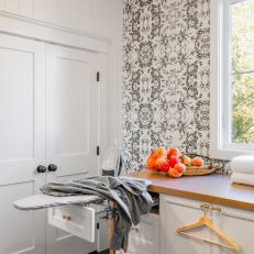 Black and White Laundry Room With Orange Flowers