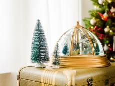 Skip the tiny snowglobe and opt for a new take on the classic Christmas village. Pick the right light fixture, and this clever DIY will make the perfect addition to any holiday decor.