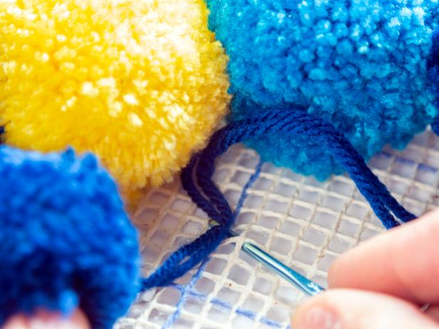 Learn how to make a fun and colorful pompom rug.