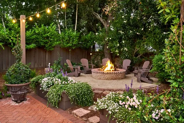 A complete backyard design with a lawn, patio, and play area.