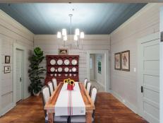 As seen on Home Town, Hosts Ben and Erin Napier renovated the dining room and revealed all the original wall paneling that was originally on the walls.  The bold paint colors on the walls, trim and ceiling also help this room to stand out as a strong feature in the Rahaim residence. (after)