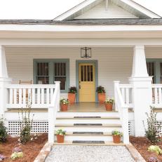 White Craftsman Home Exterior with Green Trim and Yellow Front Door 