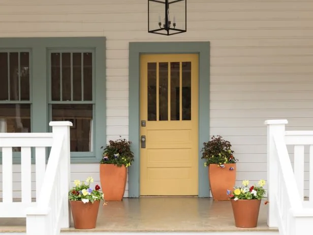 As seen on Home Town, Hosts Ben and Erin Napier redesigned the exterior of the Rahaim residence to a craftsman style with large tapered columns to accent the large front porch. (after)