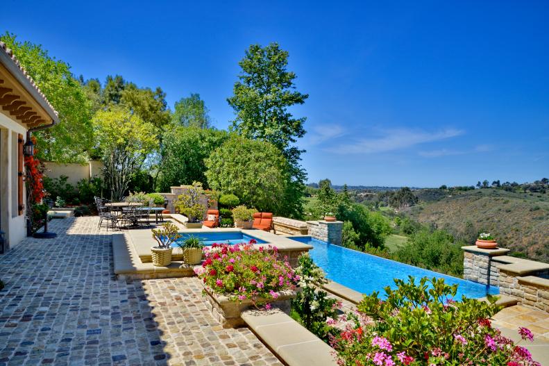 Mediterranean patio with infinity-edge pool
