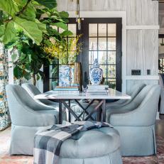 Dining Room Features Blue Upholstered Chairs and Ottomans