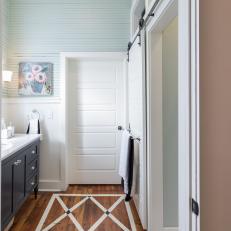 Rustic White Master Bathroom With White Door 