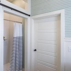 Rustic White Master Bathroom with White Sliding Barn Door 