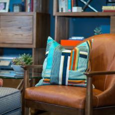 Brown Leather Armchair and Colorful Pillow