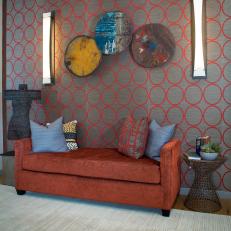 Orange and Gray Sitting Area With Velvet Sofa