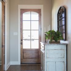 Neutral Cottage Foyer with Brown Wood Front Door 
