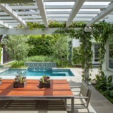 Pool, Tiled Accent Wall Framed by Pergola