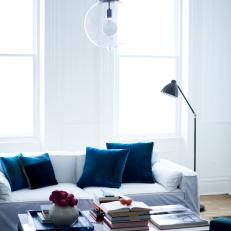 Blue and White Living Room With Glass Pendant