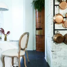 White Dining Table and Copper Pots