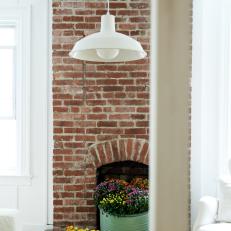 White Pendant and Brick Fireplace