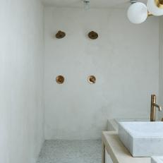 Neutral Wet Bathroom With Gold Fixtures
