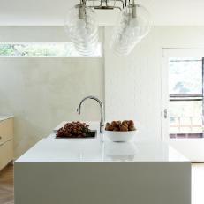 White Modern Kitchen Island and Glass Pendants