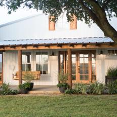 Neutral Farmhouse Home Exterior with Brown Porch Swing 