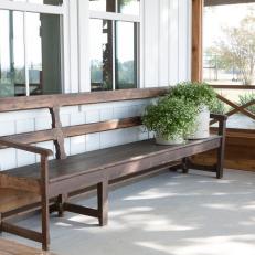 Neutral Country Screened Porch with Brown Bench 
